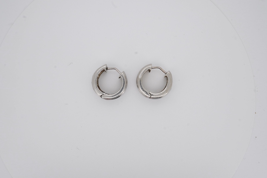 A pair of white metal and gypsy set five stone diamond hoop earrings, diameter 17mm, gross weight 8.4 grams. Condition - fair